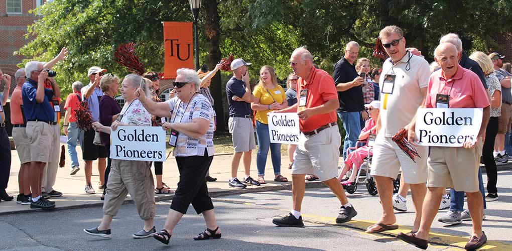 Alumni award winners marching in Homecoming Parade